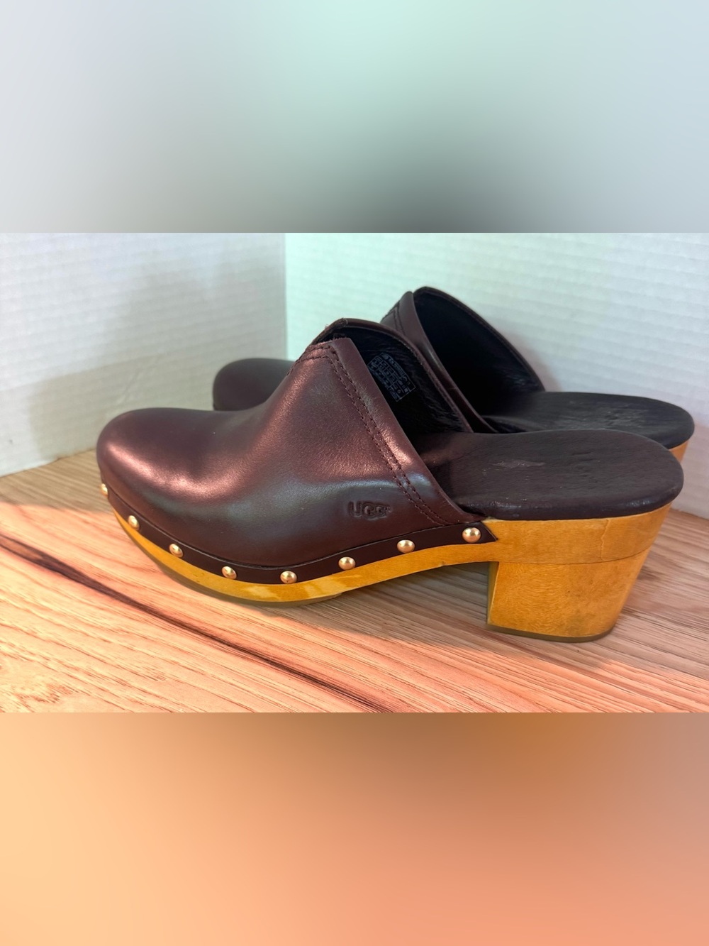 UGG Kay women's clogs in chocolate brown leather with wooden heel.